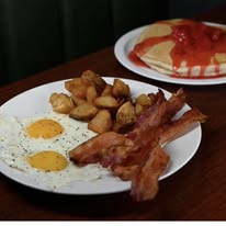 Eggs, bacon, potatoes and pancakes